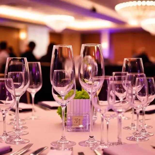 An elegant corporate event setting with beautifully arranged glassware.